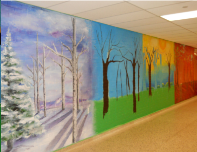 painted mural on wall showing trees in different seasons - winter, fall